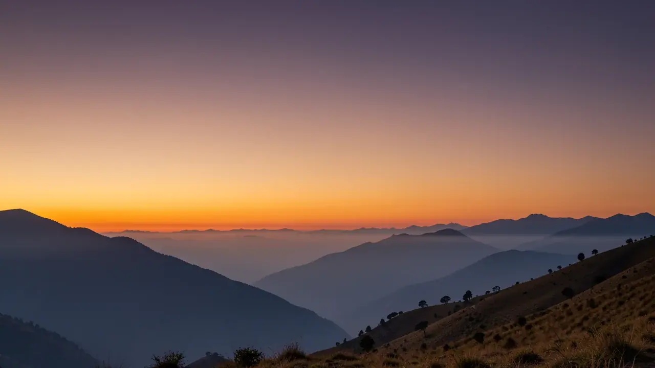 Sunset over layered Andean ridges in Ecuador, amber and violet sky
